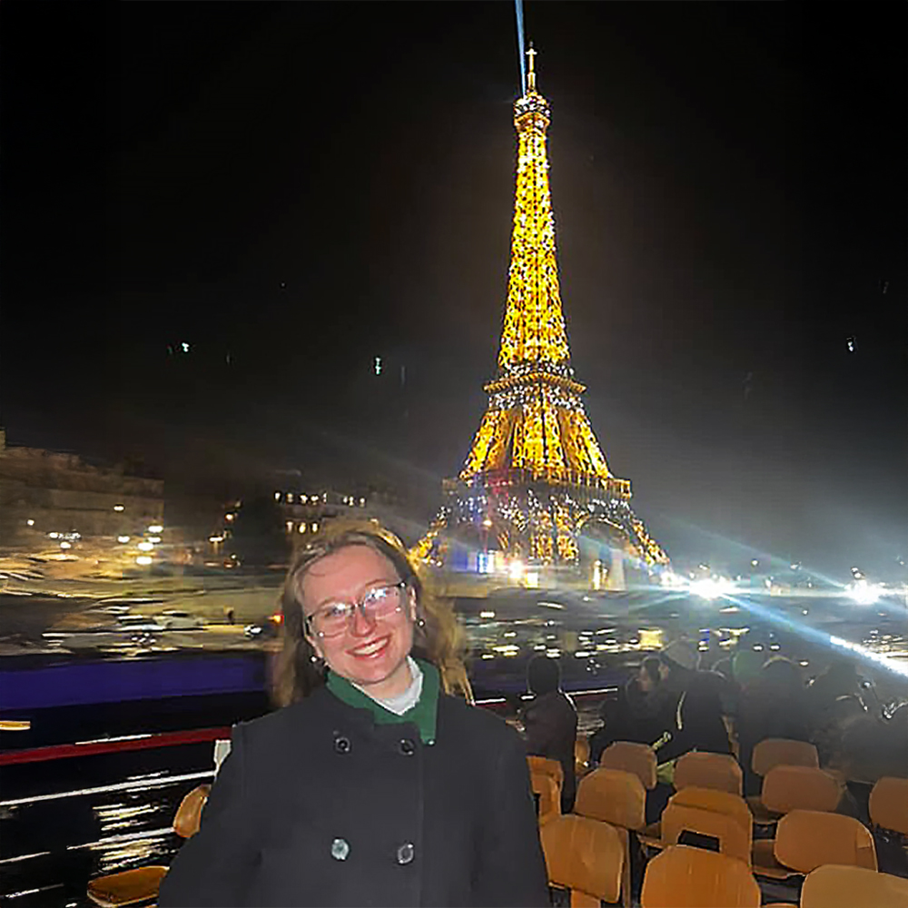 Student in front of Eiffel Tower.