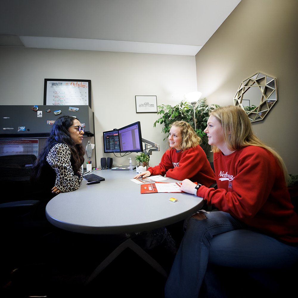 Students talking with a faculty member.