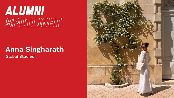 Red banner with text "Alumni Spotlight." Woman in white dress stands by a flowering vine on a tan wall.